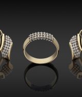 gold ring and earrings with diamonds on dark background